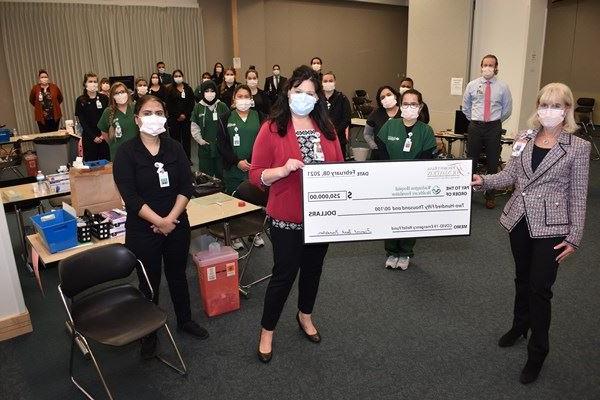 A group holding a large check